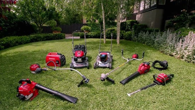 Honda outdoor power lineup — mowers, generator, blowers, and trimmers on a green lawn