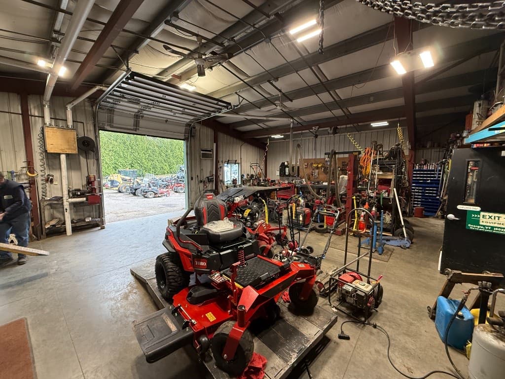 Exit 18 Equipment service bay with mower being repaired